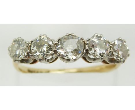 An 18ct gold ring set with five diamonds, the central diamond of approximately 0.33ct, 2.8g, size N/O