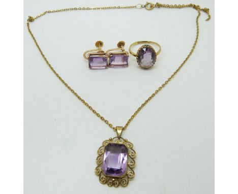 An 18ct gold ring set with an oval amethyst, a yellow metal pendant marked 333 set with an amethyst and a pair of yellow meta