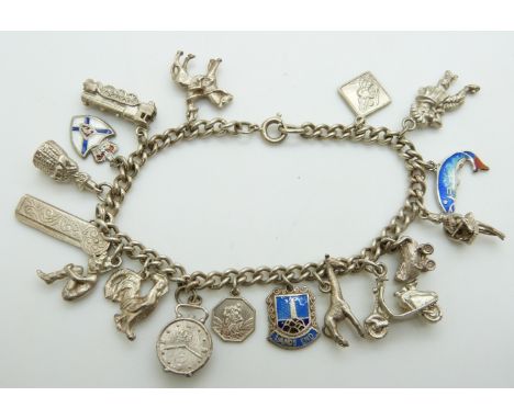 A silver bracelet with 16 charms including enamel fish, giraffe etc&nbsp;