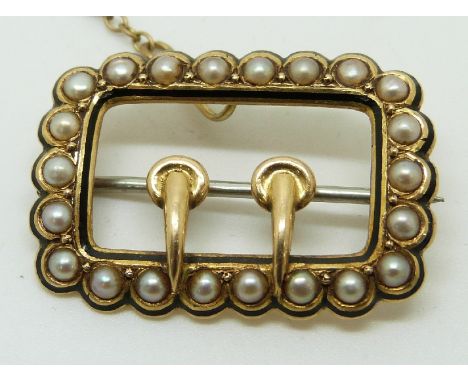 A Victorian brooch set with seed pearl and enamel in the form of a buckle