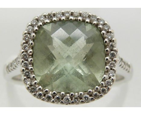 An 18ct white gold ring set with a mixed cut aquamarine surrounded by diamonds, 4.6g, size M