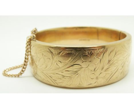 A 9ct gold bangle with engraved decoration, 36.2g