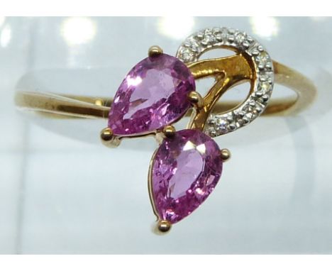 A 9ct gold ring set with diamonds and pear cut pink sapphires, 1.8g, size N