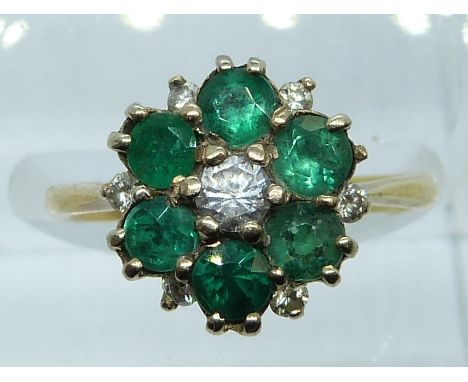 A yellow metal ring set with emeralds, diamonds and paste in a cluster, 4g, size K