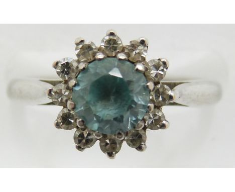 An 18ct white gold ring set with a round cut zircon and surrounded by diamonds, 3.9g, size J/K