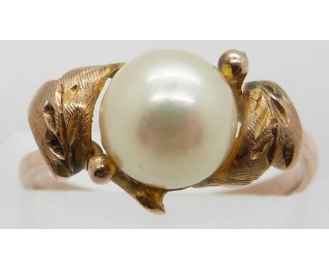 A yellow metal ring set with a pearl in a foliate design, 2.1g, size J