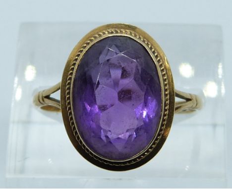 A 9ct gold ring set with an oval cut amethyst, 3.4g, size P