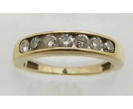 A 9ct gold ring set with seven round cut diamonds, 2.6g, size L