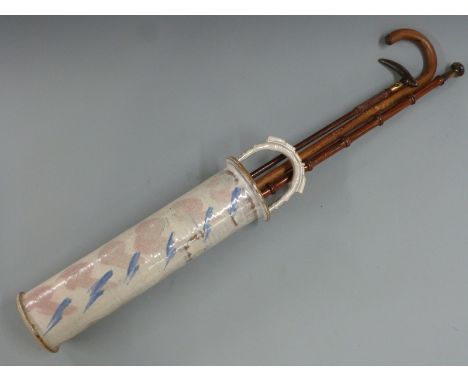 Two horn or similar handled walking sticks/canes, further walking stick and a ceramic stick stand