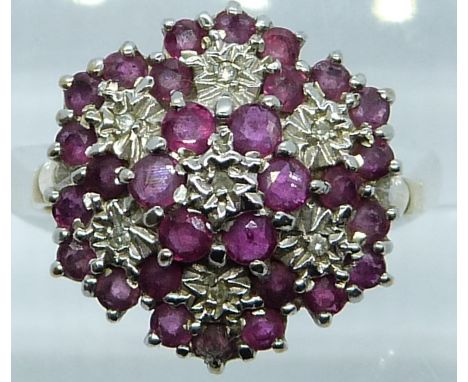 A 9ct gold ring set with a ruby and diamonds in a large cluster, 3.5g, size O
