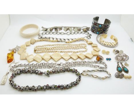 A collection of costume jewellery including Otazu necklace, silver pendants, pressed amber pendant, white metal bangle, silve