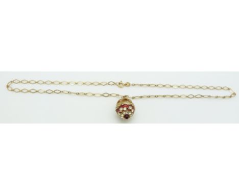 A 9ct gold chain with a silver gilt enamel egg pendant, 3.2g