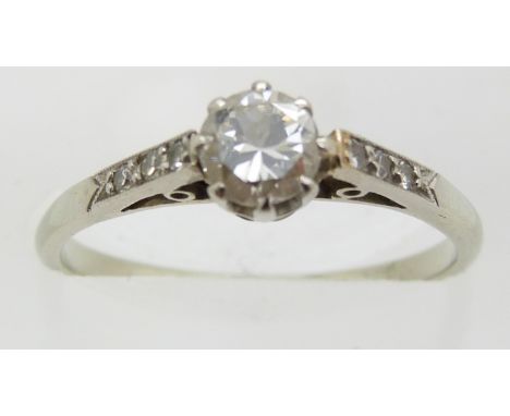 An 18ct white gold ring set with a diamond of approximately 0.35ct with diamond encrusted shoulders, 2.1g, size M