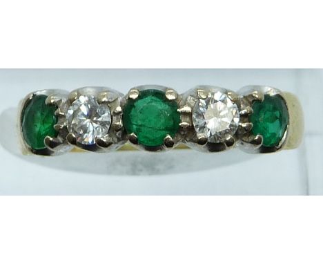 An 18ct gold ring set with diamonds and emeralds of approximately 0.2ct, 4.3g, size O