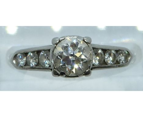 A platinum ring set with a diamond of approximately&nbsp;0.65ct&nbsp;and six further diamonds to the shoulders, 4.4g, size N