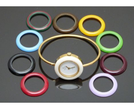 Gucci gold plated ladies wristwatch with gold hands, white dial and ten interchangeable bezels of various colours, on gold pl