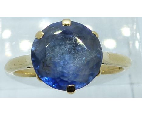 An 18ct gold ring set with a round cut synthetic sapphire, 5.6g, size P/Q