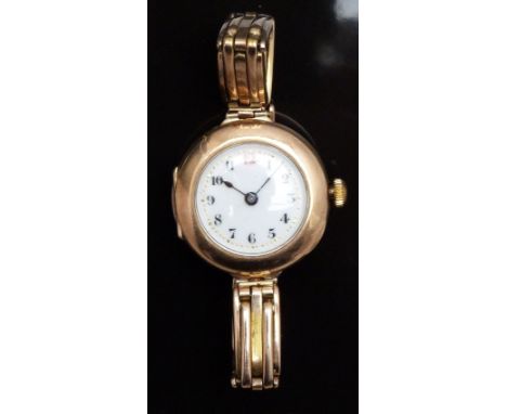 Vintage 9ct gold ladies wristwatch with blued hands, black Arabic numerals, white enamel dial and gilt minute markers, on exp