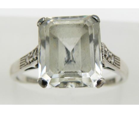 An 18ct gold ring set with an emerald cut white sapphire and diamonds, marked Parsons, 3.9g, size N