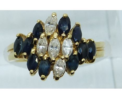 An 18ct gold ring set with marquise cut sapphires and diamonds, 5.3g, size K