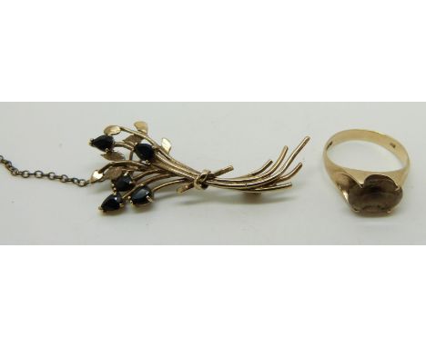 A 9ct gold ring set with a smoky quartz and a 9ct gold brooch set with sapphires, 5.4g