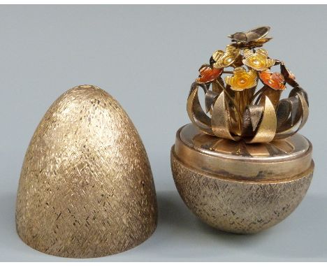 Stuart Devlin limited edtition hallmarked silver gilt egg with bark effect exterior and butterfly amongst enamel flowers to i