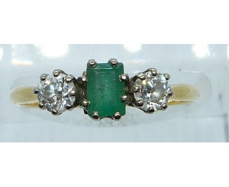 An 18ct gold ring set with an emerald of approximately 0.35ct and two diamonds each approximately&nbsp; 0.25ct, 2.6g, size N/