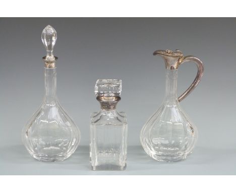 Silver mounted decanter set comprising claret jug and two decanters, the mounts on each marked sterling and with prancing hor