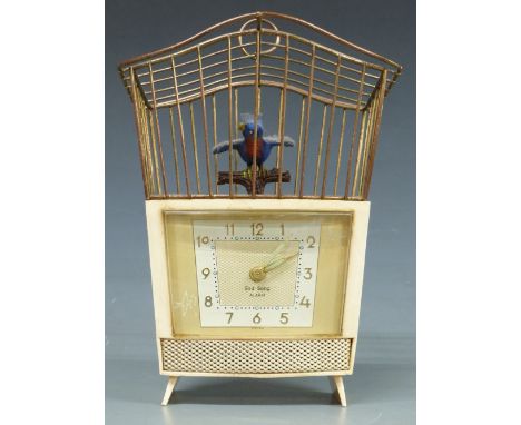 1950s bird-song alarm clock in ivory coloured Bakelite case, the Arabic dial with luminous indicators and hands, bird in cage