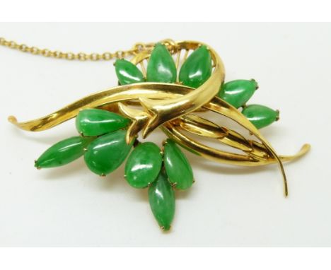 A 14k gold brooch set with pear cut jade cabochons, 5 x 3cm