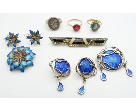 A silver brooch set with blue enamel with matching earrings, a silver brooch in the form of a flower set with blue enamel wit