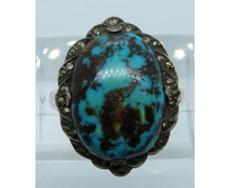 A 9ct gold and silver ring set with turquoise and marcasite, 6.1g, size L