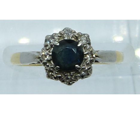 An 18ct gold ring set with a sapphire and diamonds, 2.8g, size J