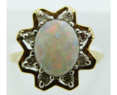 An 18ct gold ring set with an opal and diamonds, 4.3g, size I