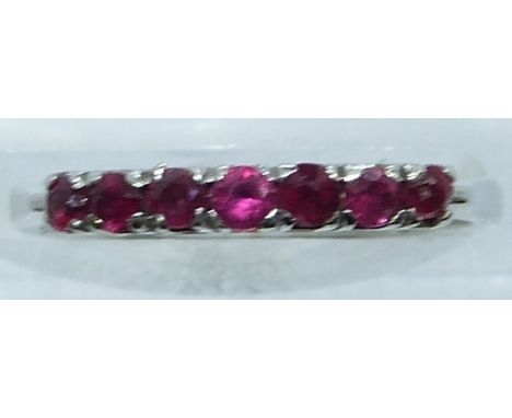 An 18ct white gold ring set with rubies, 2.4g, size K