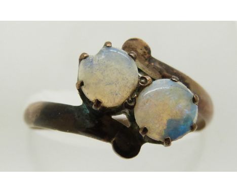 A yellow metal ring set with two opals, 1.5g, size O