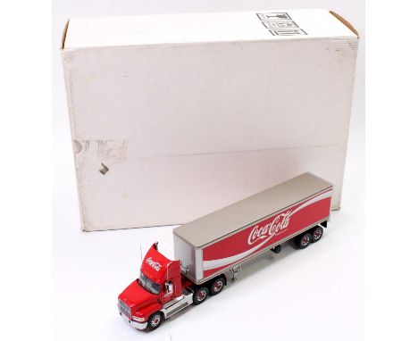 A Franklin Mint Precision Models 1/43rd scale Mack CH 600 box truck in "Coca-Cola" livery, as issued in its polystyrene packe