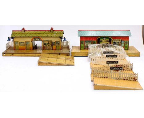 Two Hornby stations: buff building, tinprinted speckled platform, round top arch over booking hall, blue lamps, some marks pa