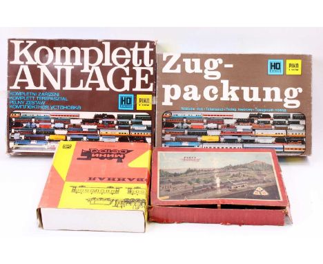 A collection fo four various boxed Piko and Russian H0 scale boxed train sets, to include a diesel 106-256-1 locomotive and c