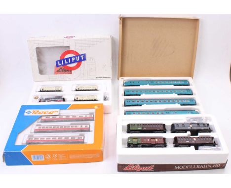 A collection of Liliput, Roco and H0 scale boxed coach packs and train sets to include a Roco No. 4306 coach pack, a Liliput 
