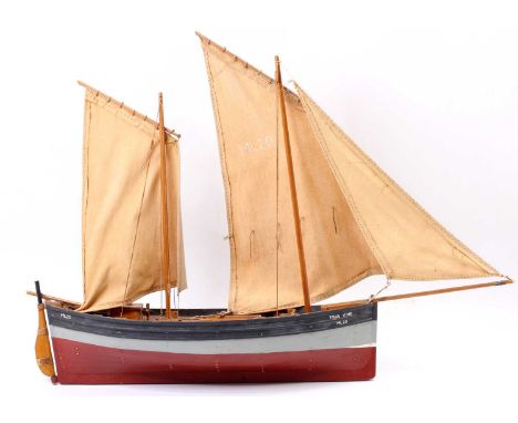 A scratchbuilt hot air engine powered steam launch, comprising of wooden hull with removable super structure to reveal a hot 