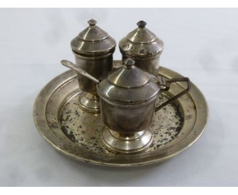 A three piece silver Art Deco condiment set on matching tray, Birmingham 1920 by Richard Comyns