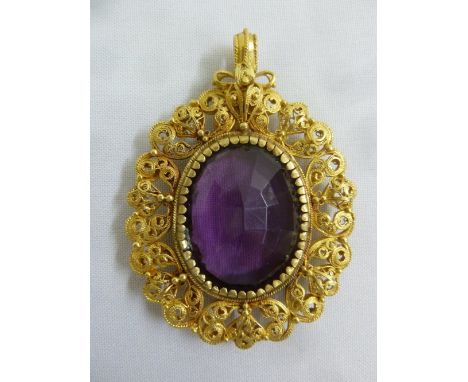 A large amethyst set in a gold filigree pendant, gold tested 18ct, approx total weight 54.0g