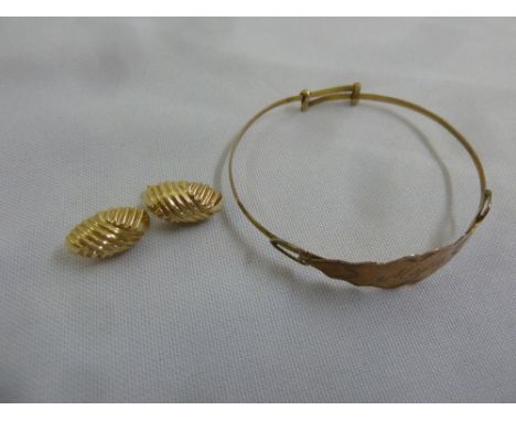 A gold bangle tested 9ct and a pair of 9ct yellow gold earrings, approx total weight 7.1g