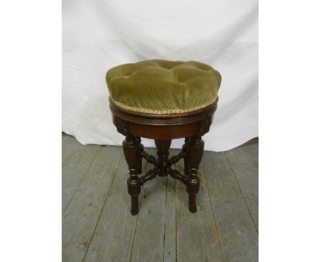 A mahogany circular upholstered stool on four turned legs
