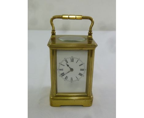 Brass carriage clock of customary form, enamel dial with Roman numerals
