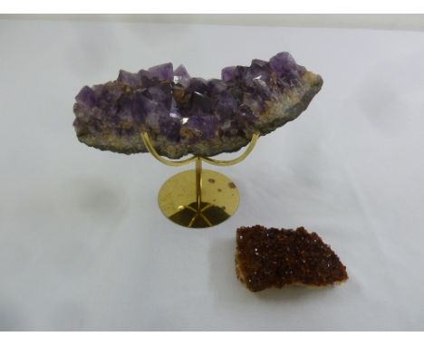An amethyst section on brass stand and a smaller amethyst section