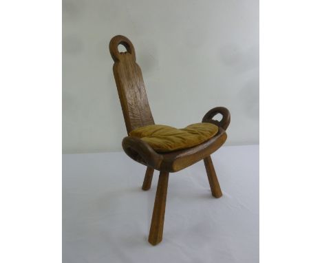 A rustic oak three legged stool