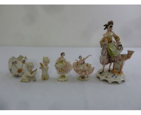 A quantity of Continental ceramic figurines to include a pair of Dresden lace figures and two putti