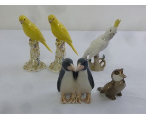 A pair of Royal Worcester figurines of birds and three others